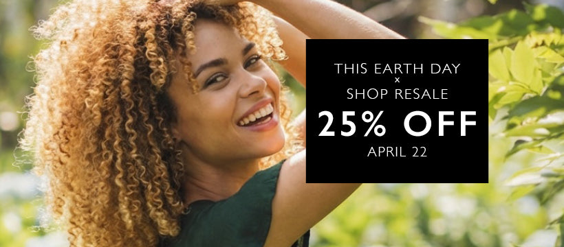 Woman with curly hair smiling outdoors with a promotional banner for Earth Day sale.